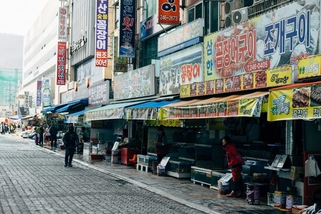 People Walking on Sidewalk Near Store