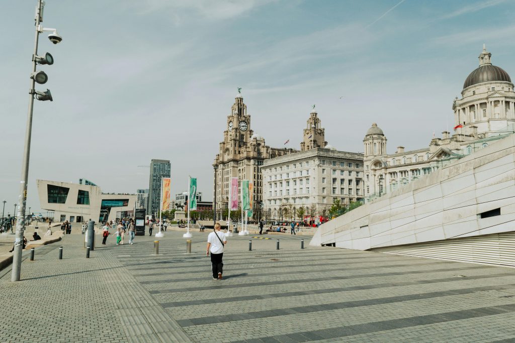 Daytime view of iconic buildings in Liverpool, England, showcasing urban life and historic architecture.