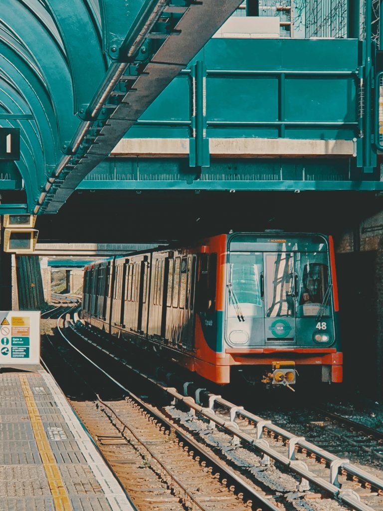 pexels-photo-28543483-28543483 A Docklands Light Railway train arriving at a London station on a bright summer day.